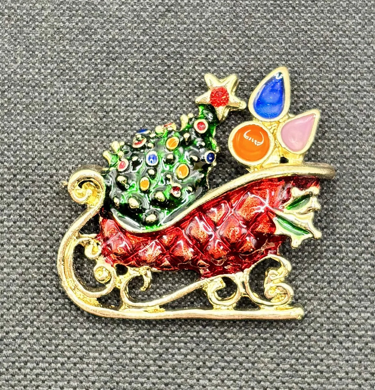Enamel crystal sled needle minder on dark fabric