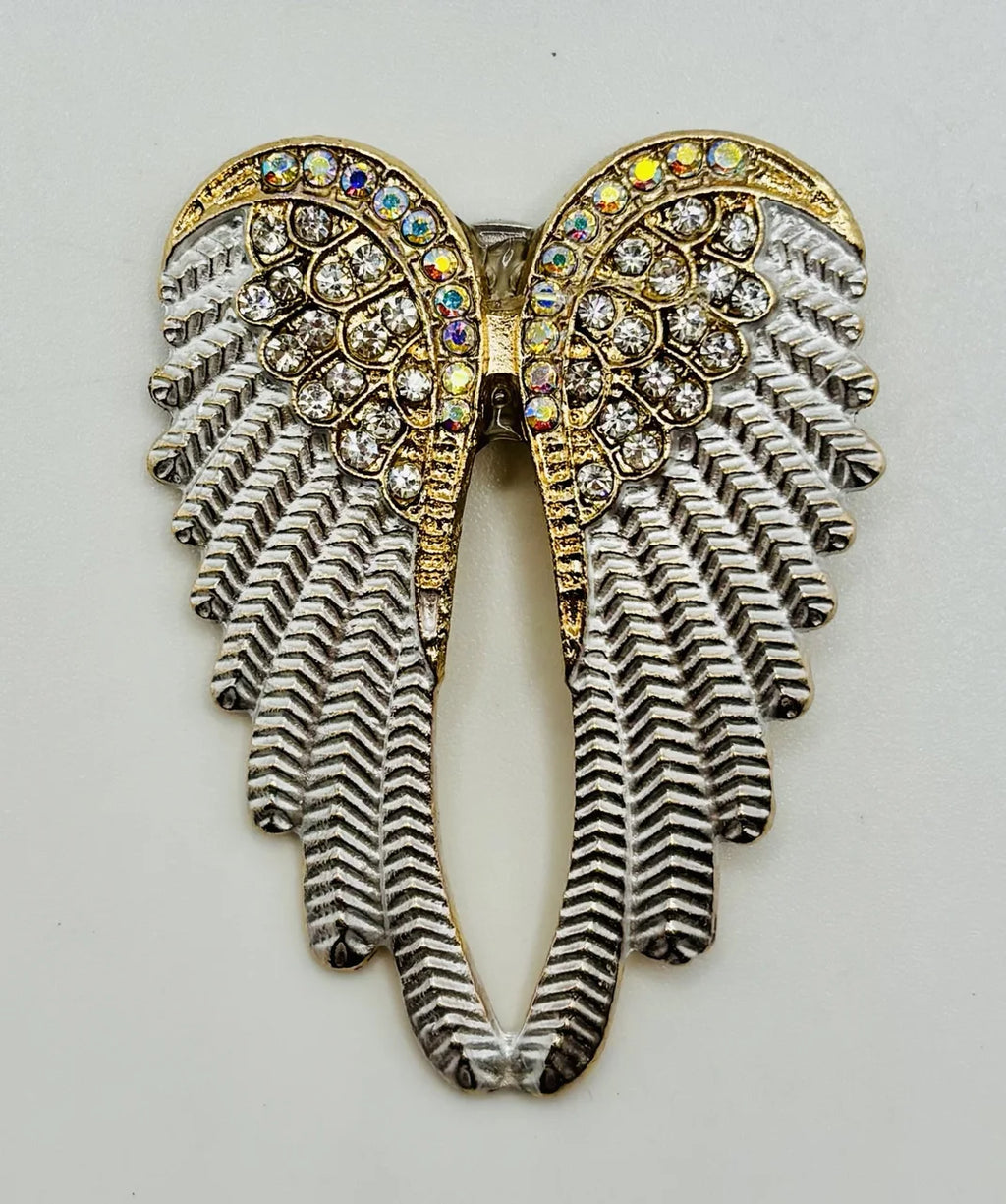 White enamel and crystal angel wings needle minder on a white background