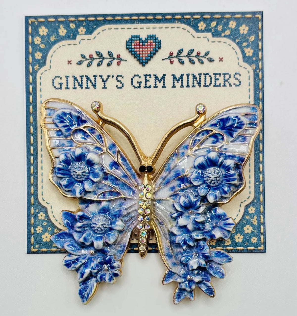 Blue enamel butterfly needle minder on Ginny’s Gem Minders display card