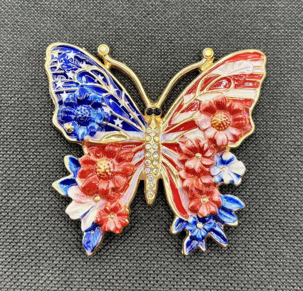 Red white and red white and blue enamel butterfly needle minder on dark fabric