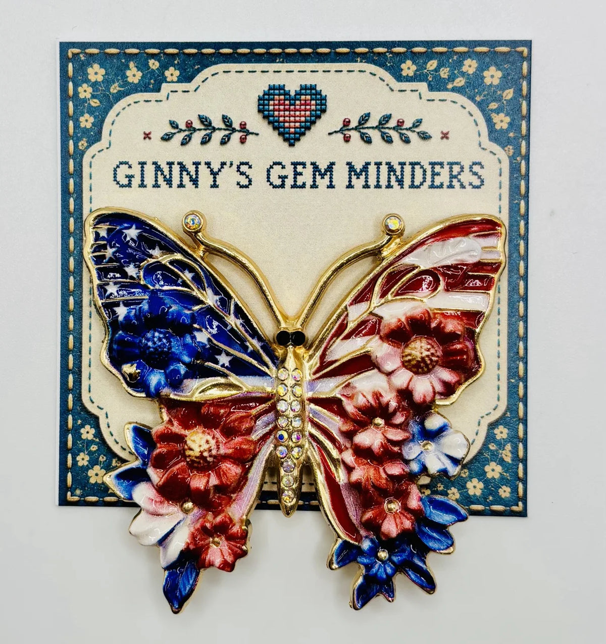 Red white and red white and blue enamel butterfly needle minder on Ginny’s Gem Minders display card