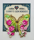 Pink and green enamel butterfly needle minder on Ginny’s Gem Minders display card