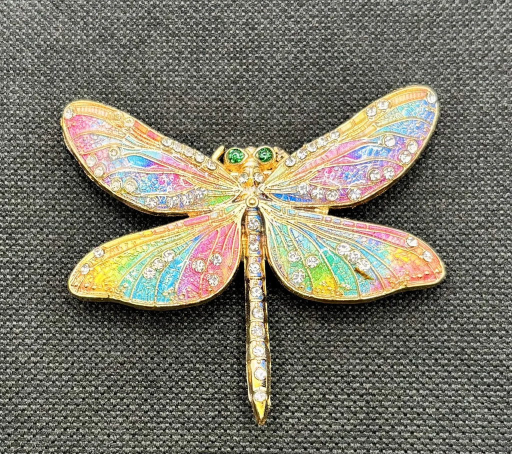 Red white and pastel rainbow enamel crystal dragonfly needle minder on dark fabric