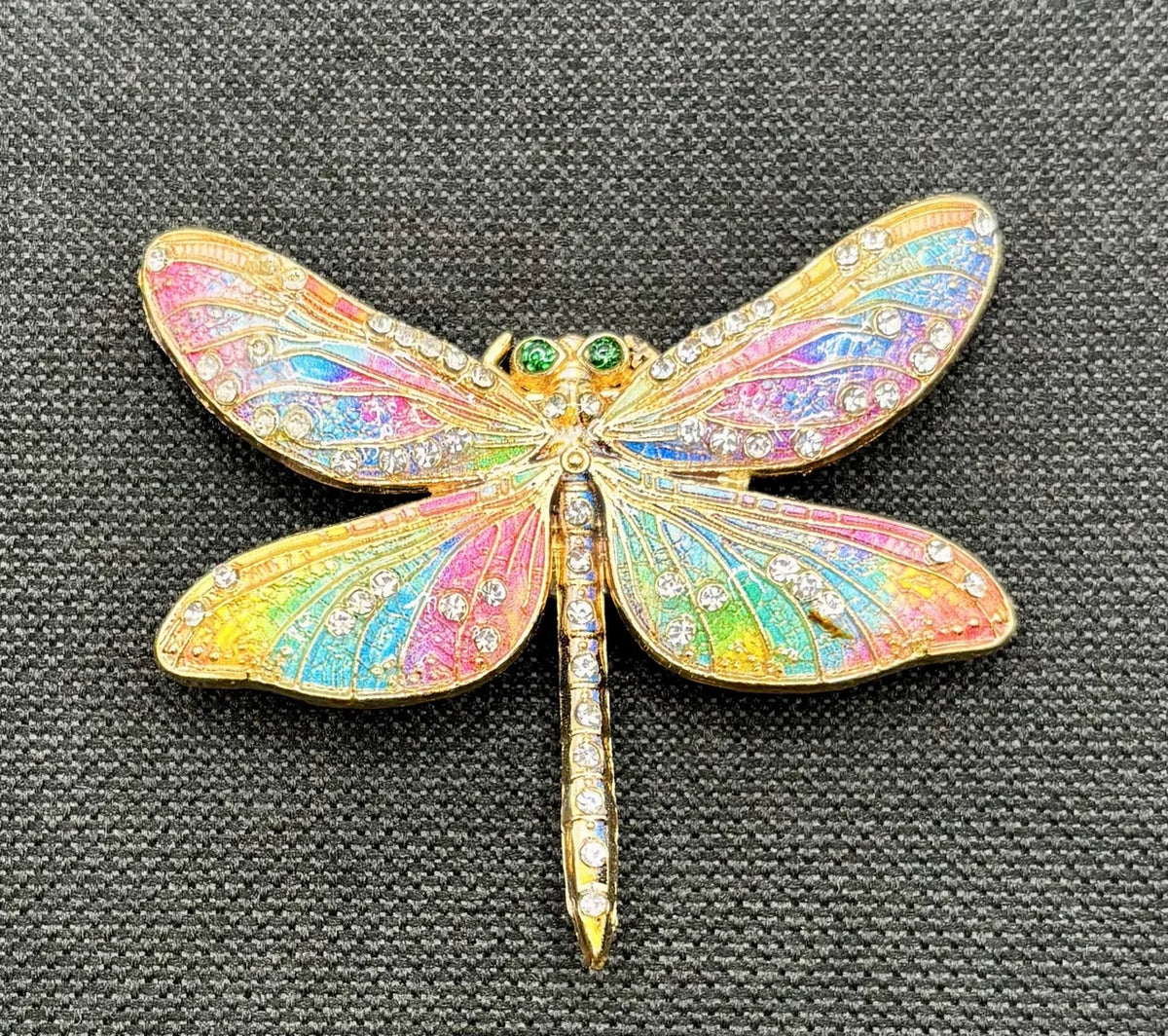 Red white and pastel rainbow enamel crystal dragonfly needle minder on dark fabric