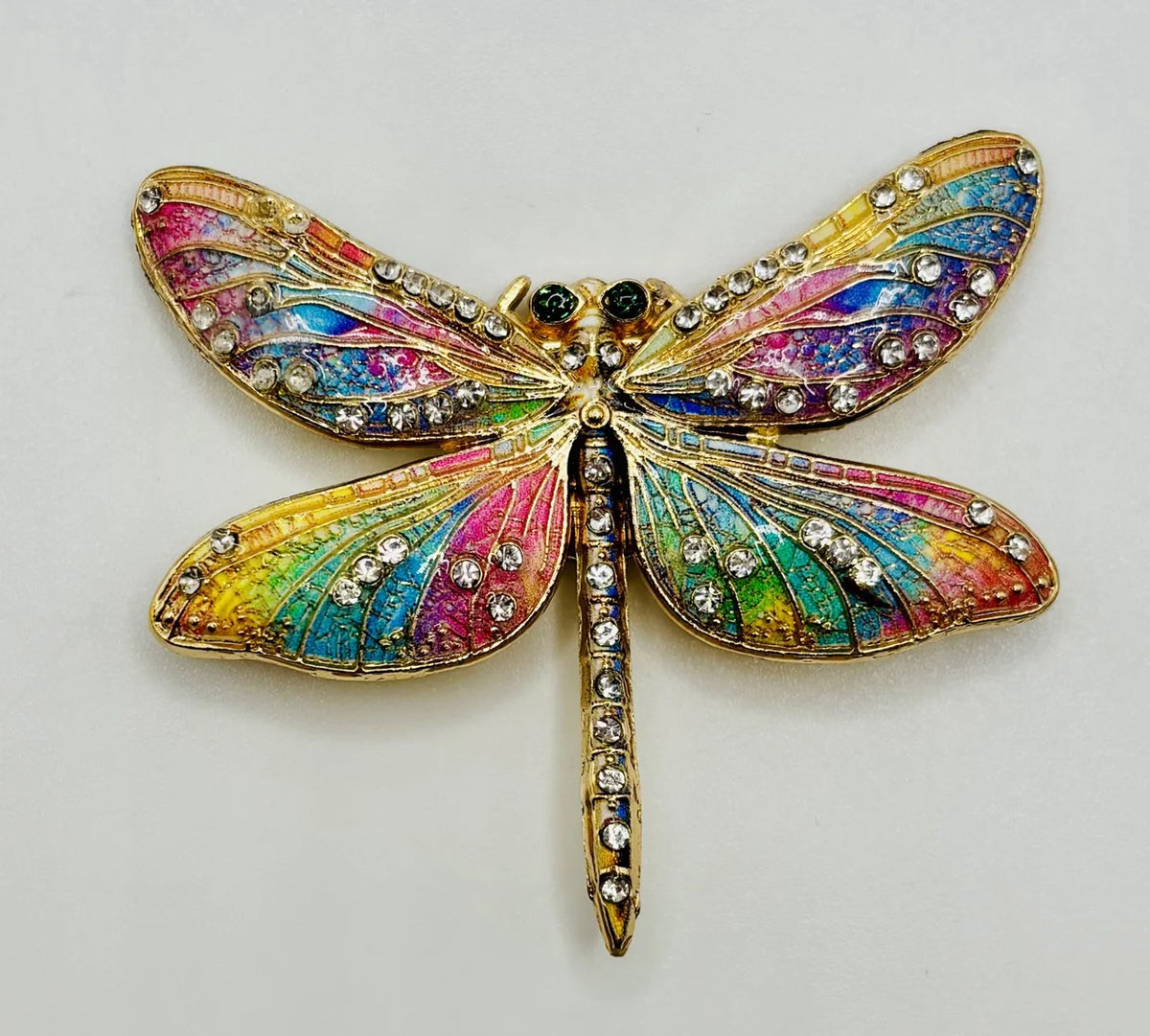 Red white and pastel rainbow enamel crystal dragonfly needle minder on a white background