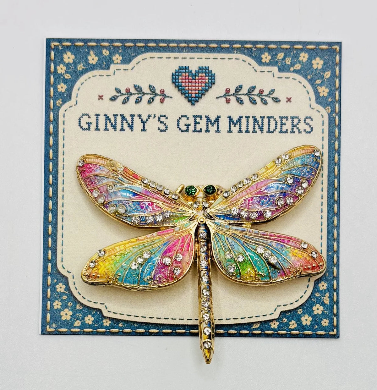 Red white and pastel rainbow enamel crystal dragonfly needle minder on Ginny’s Gem Minders display card