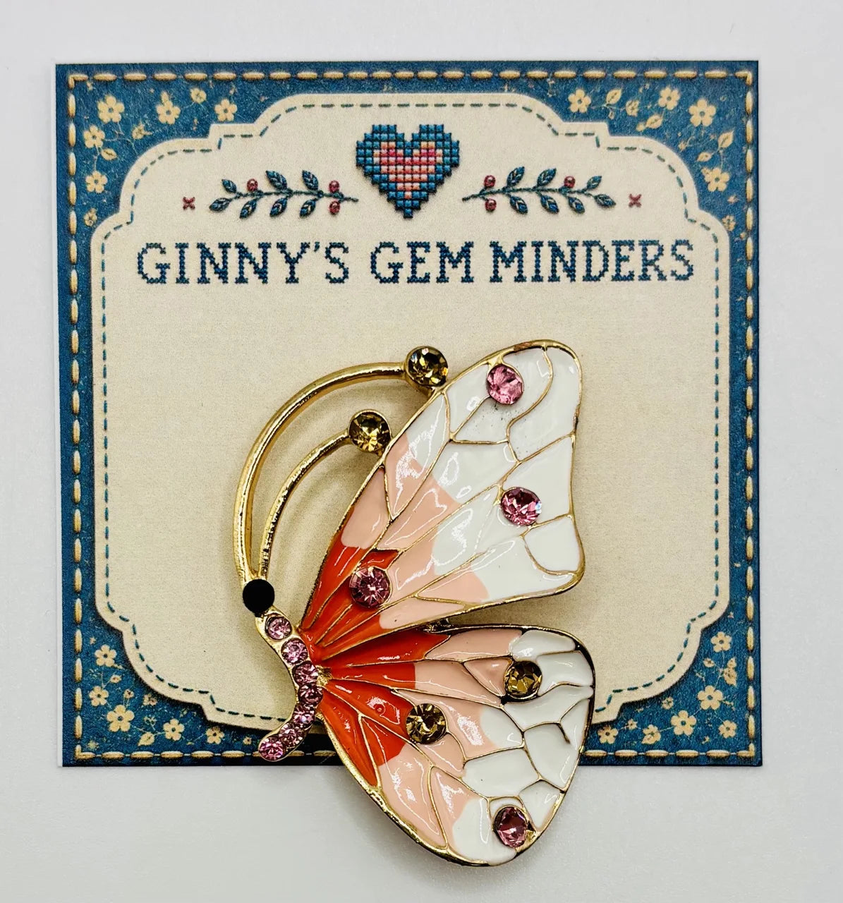 Red white and peach and white enamel and crystal butterfly needle minder on Ginny’s Gem Minders display card