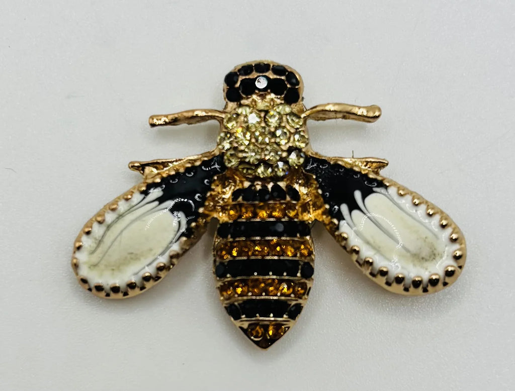 Little enamel and crystal bee needle minder on a white background