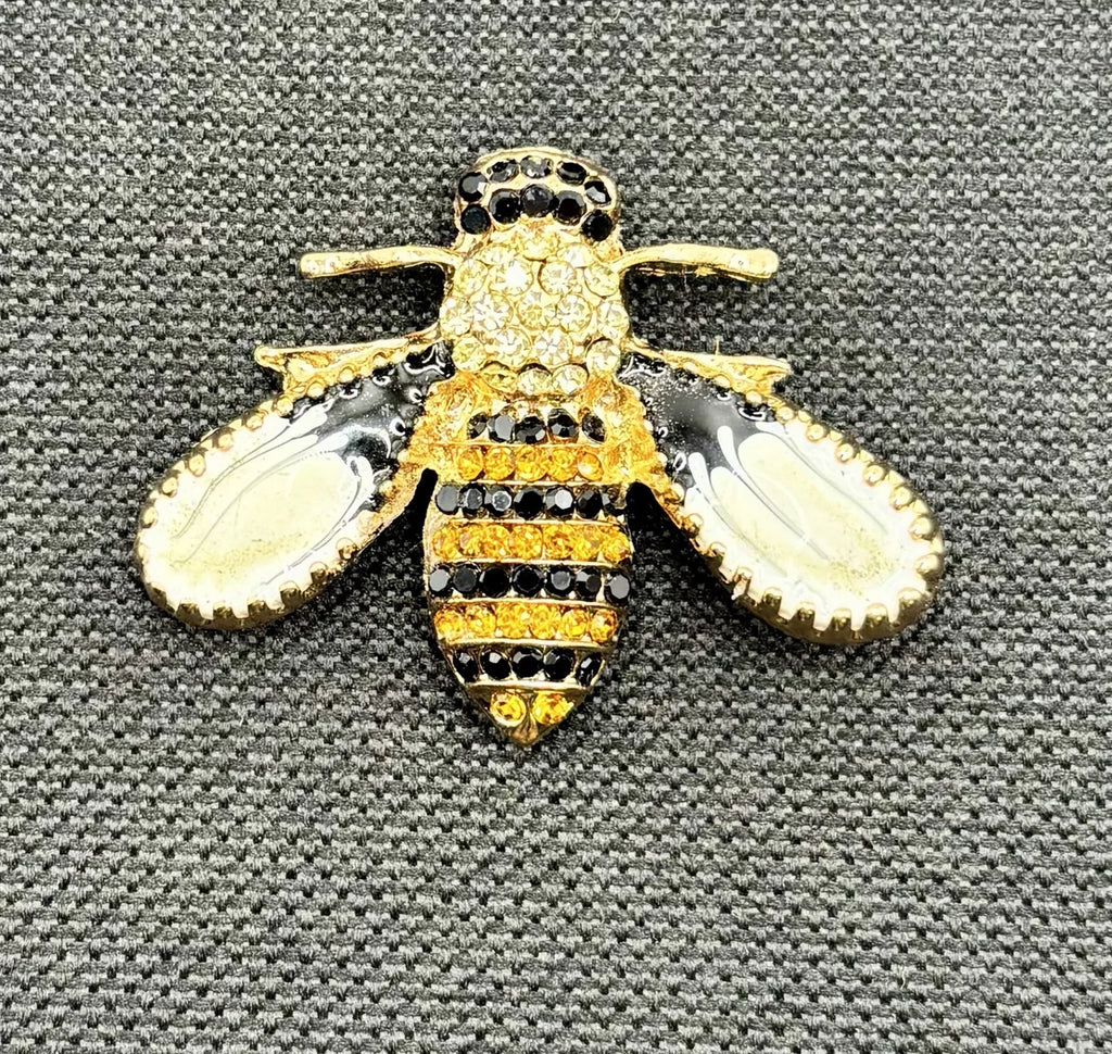 Little enamel and crystal bee needle minder on dark fabric