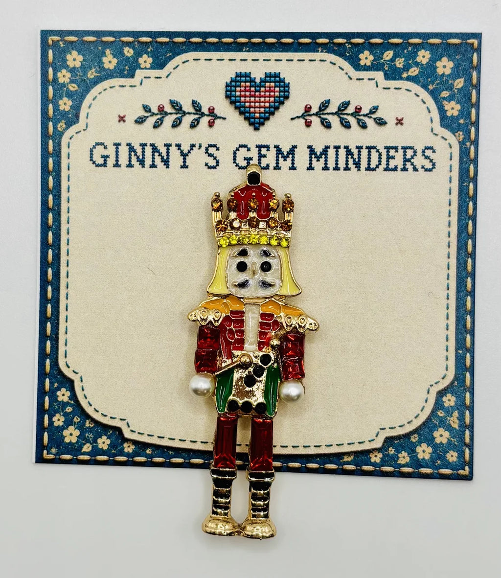 Green and red crystal nutcracker needle minder on Ginny’s Gem Minders display card