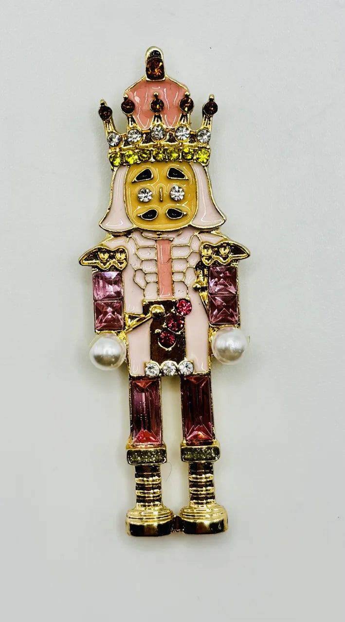 Pink crystal nutcracker needle minder on a white background