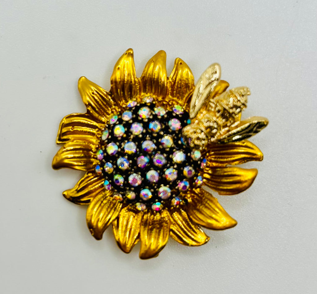 Crystal sunflower with bee needle minder on a white background