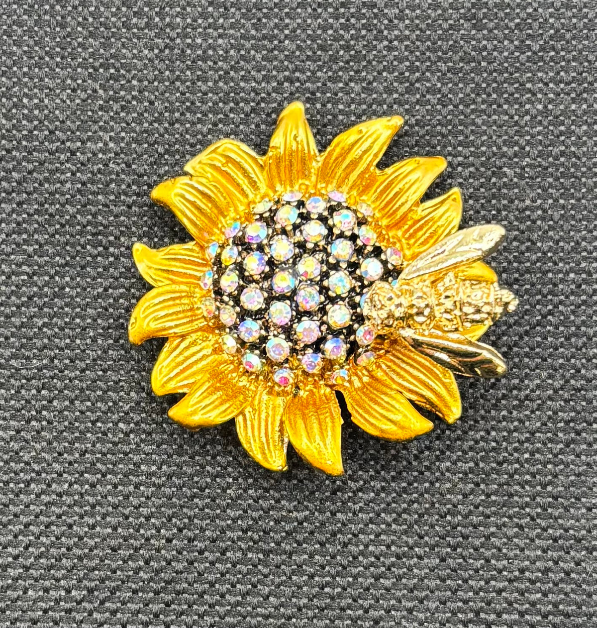 Crystal sunflower with bee needle minder on dark fabric