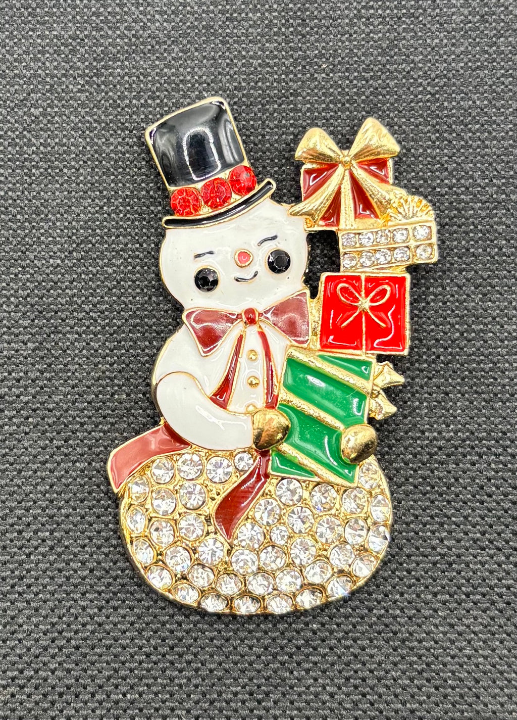 Crystal snowman with gifts needle minder on dark fabric