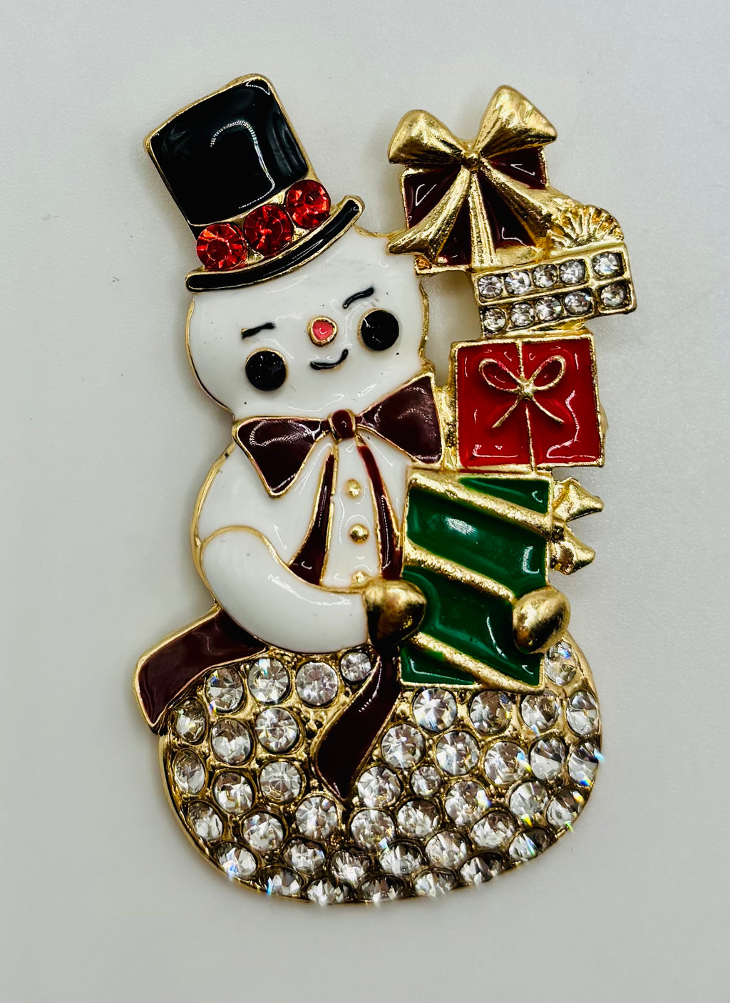 Crystal snowman with gifts needle minder on a white background