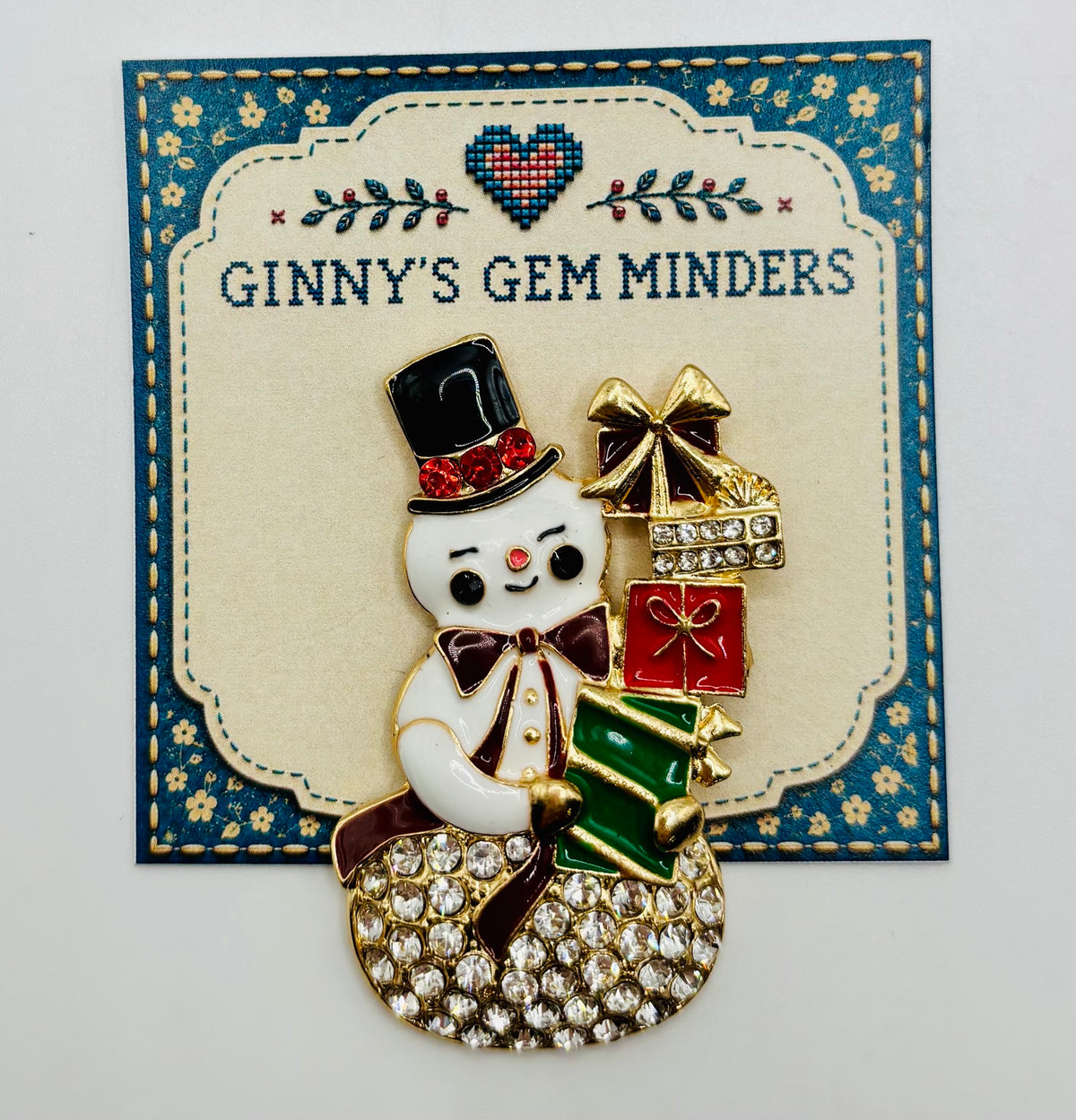Crystal snowman with gifts needle minder on Ginny’s Gem Minders display card