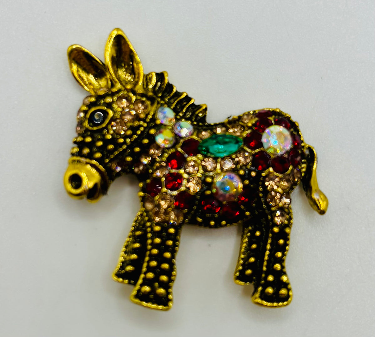 Colorful Crystal and Gold Donkey Needle Minder on white background