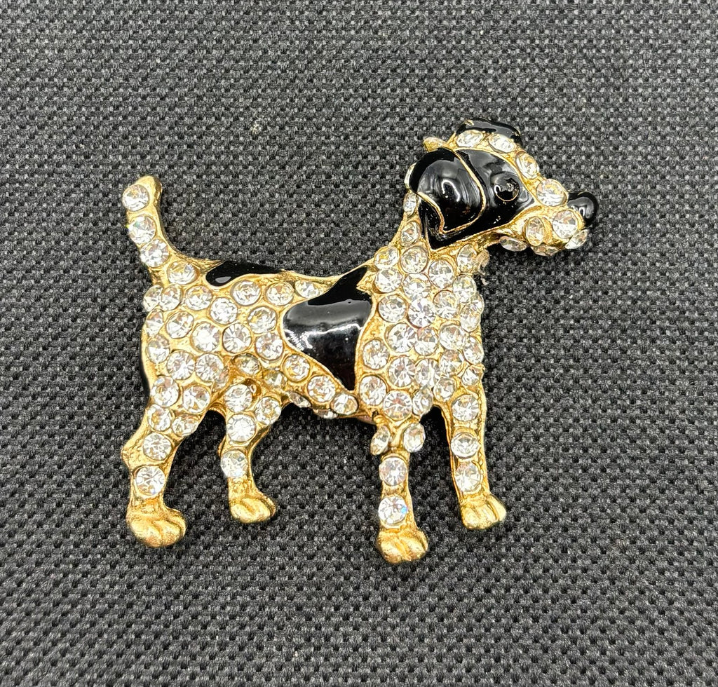 Black and crystal spotted dog needle minder on dark fabric