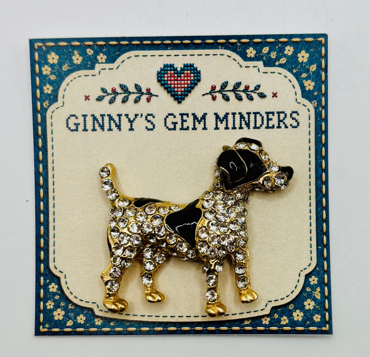 Black and crystal spotted dog needle minder on display card