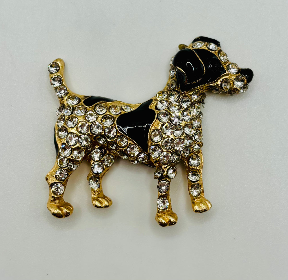Black and crystal spotted dog needle minder on white background