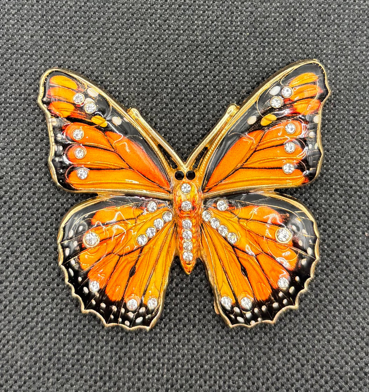 Beautiful Black/Orange Monarch Butterfly Needle Minder on dark fabric
