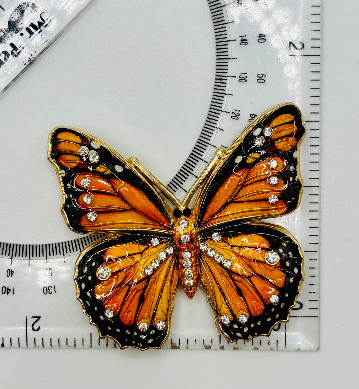 Beautiful Black/Orange Monarch Butterfly Needle Minder beside a ruler for scale