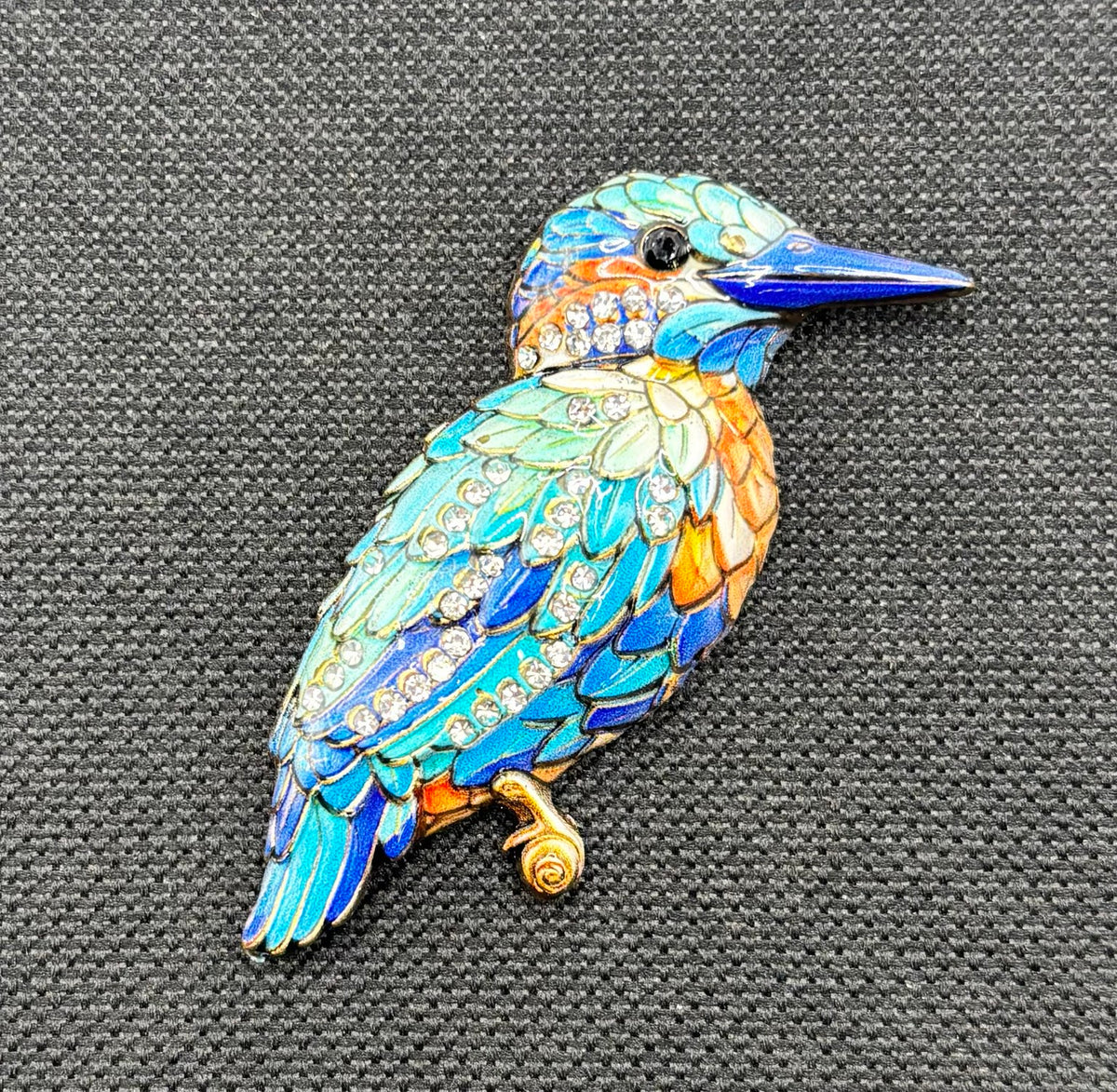 Blue enamel and crystal kingfisher needle minder — dark fabric
