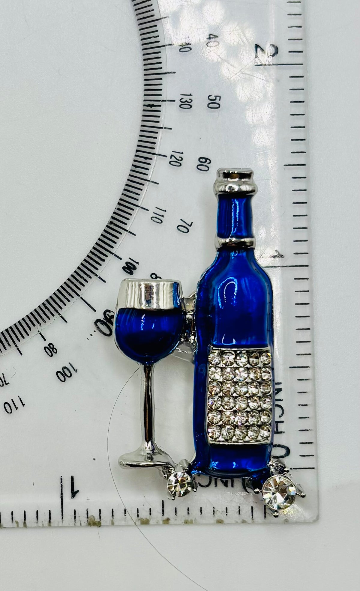 Small Blue Enamel Wine Bottle and Glass Needle Minder — ruler
