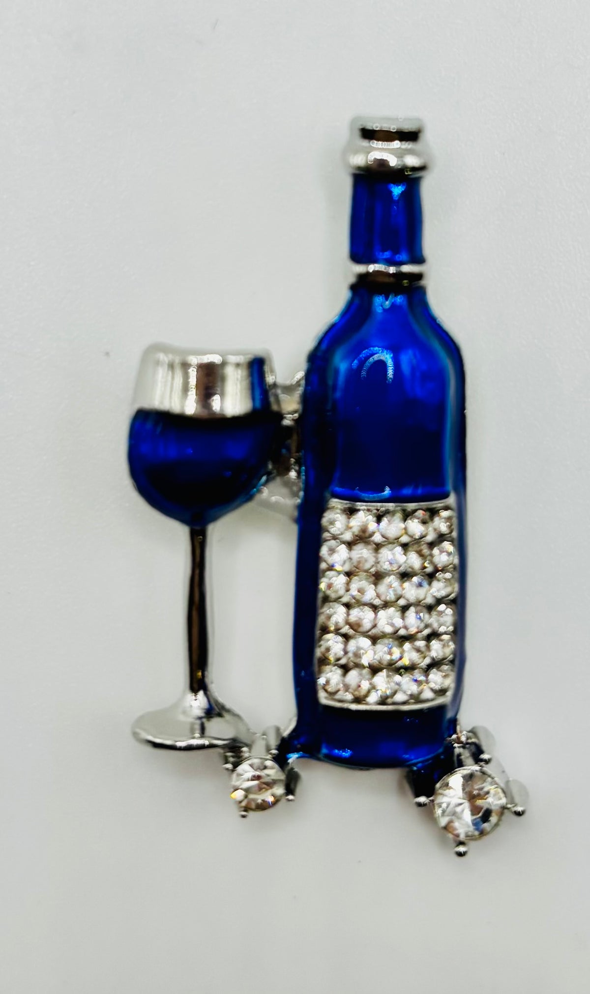 Small Blue Enamel Wine Bottle and Glass Needle Minder — white background