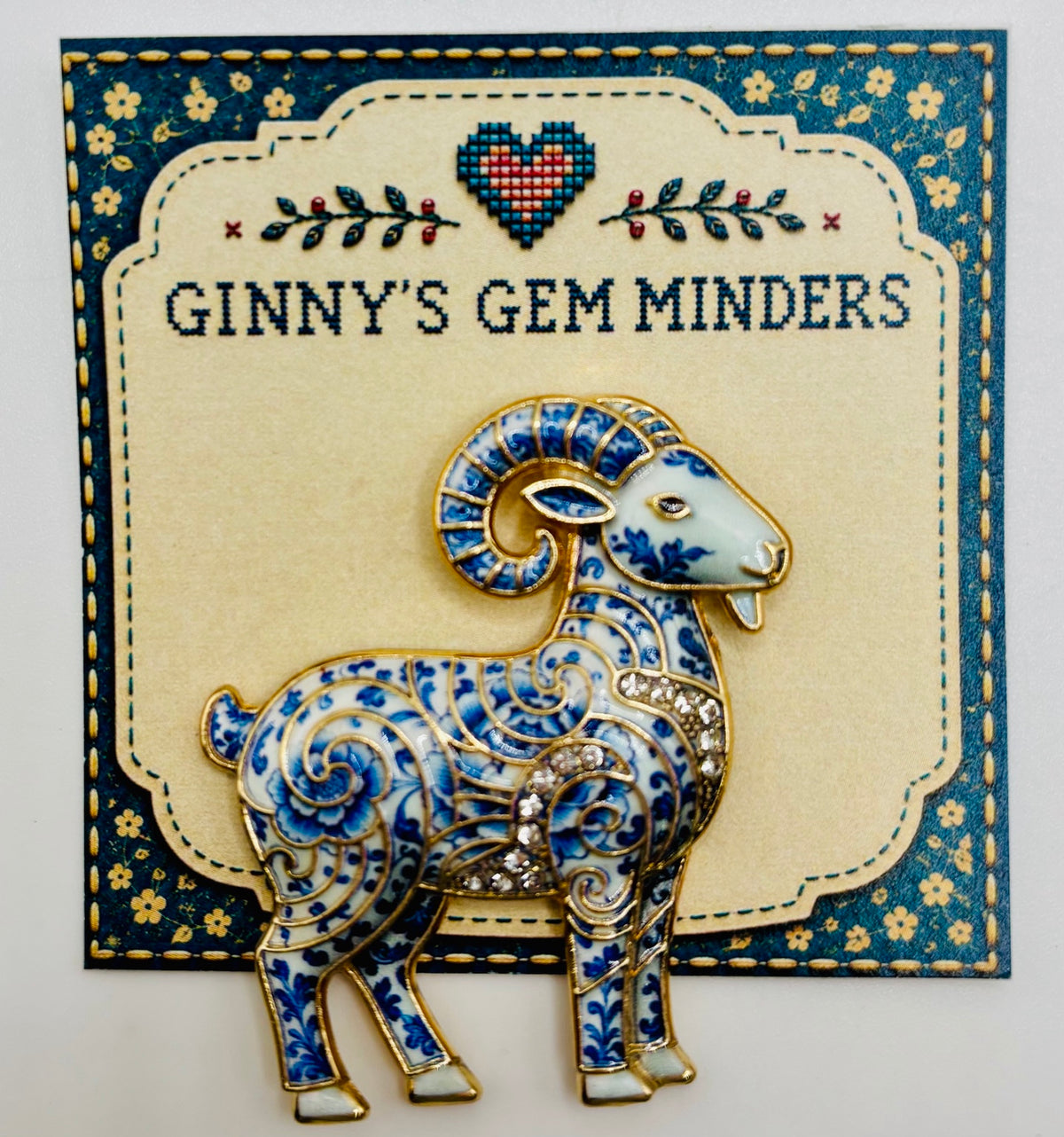 Blue white ram needle minder on display card