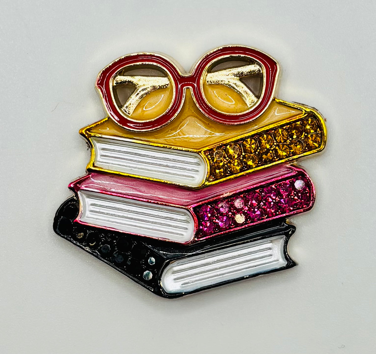 Enamel and Crystal Book Stack with Glasses Needle Minder — white background