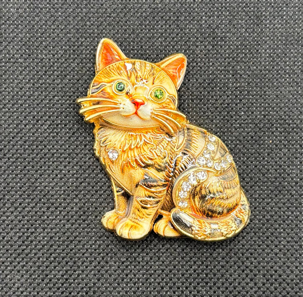 Brown tabby cat kitty needle minder on dark fabric