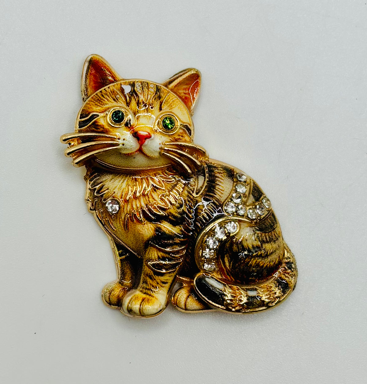 Brown tabby cat kitty needle minder on white background