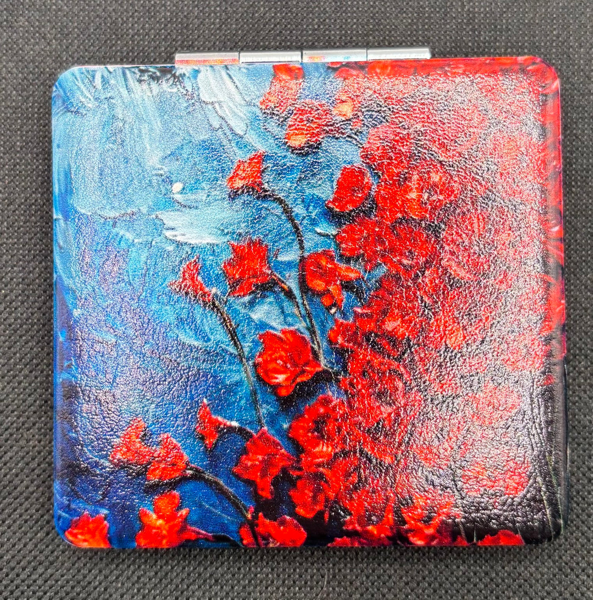 Cascade of Red Flowers Bead Case on dark fabric