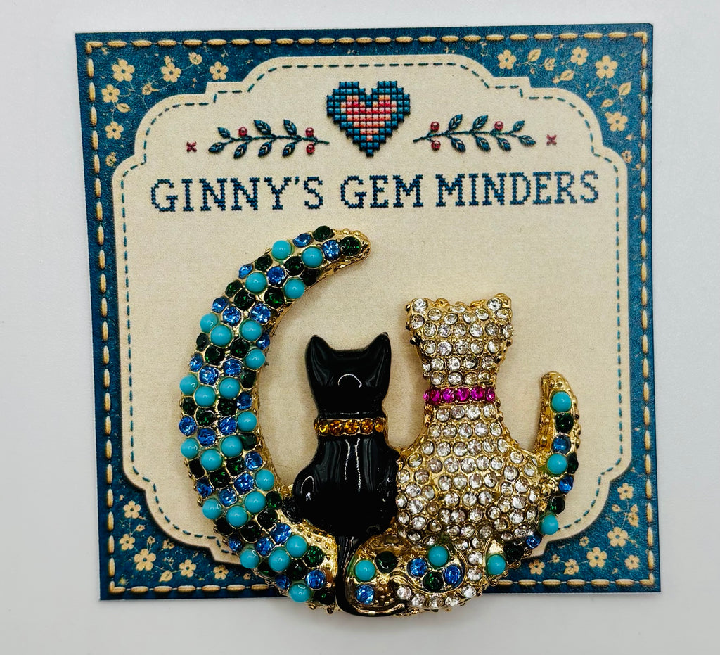 Black and crystal cats on turquoise moon needle minder on display card