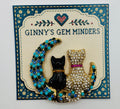 Black and crystal cats on turquoise moon needle minder on display card