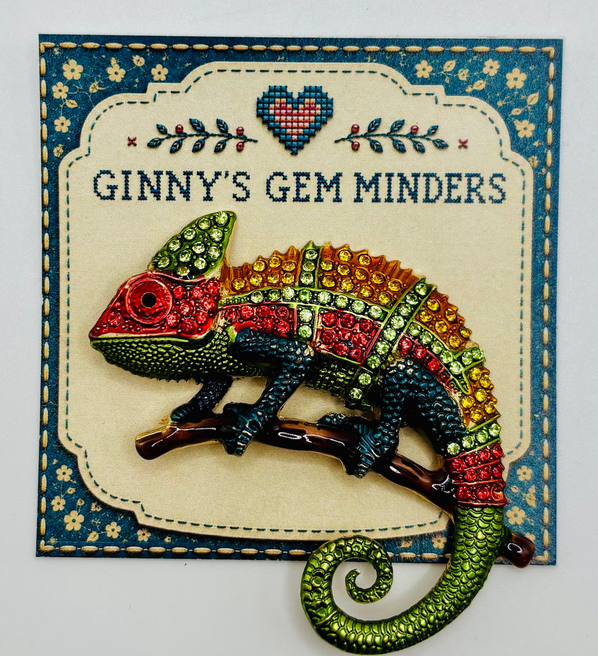Colorful crystal chameleon needle minder on display card