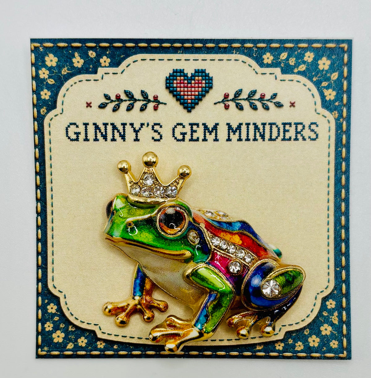 Colorful frog prince needle minder on display card
