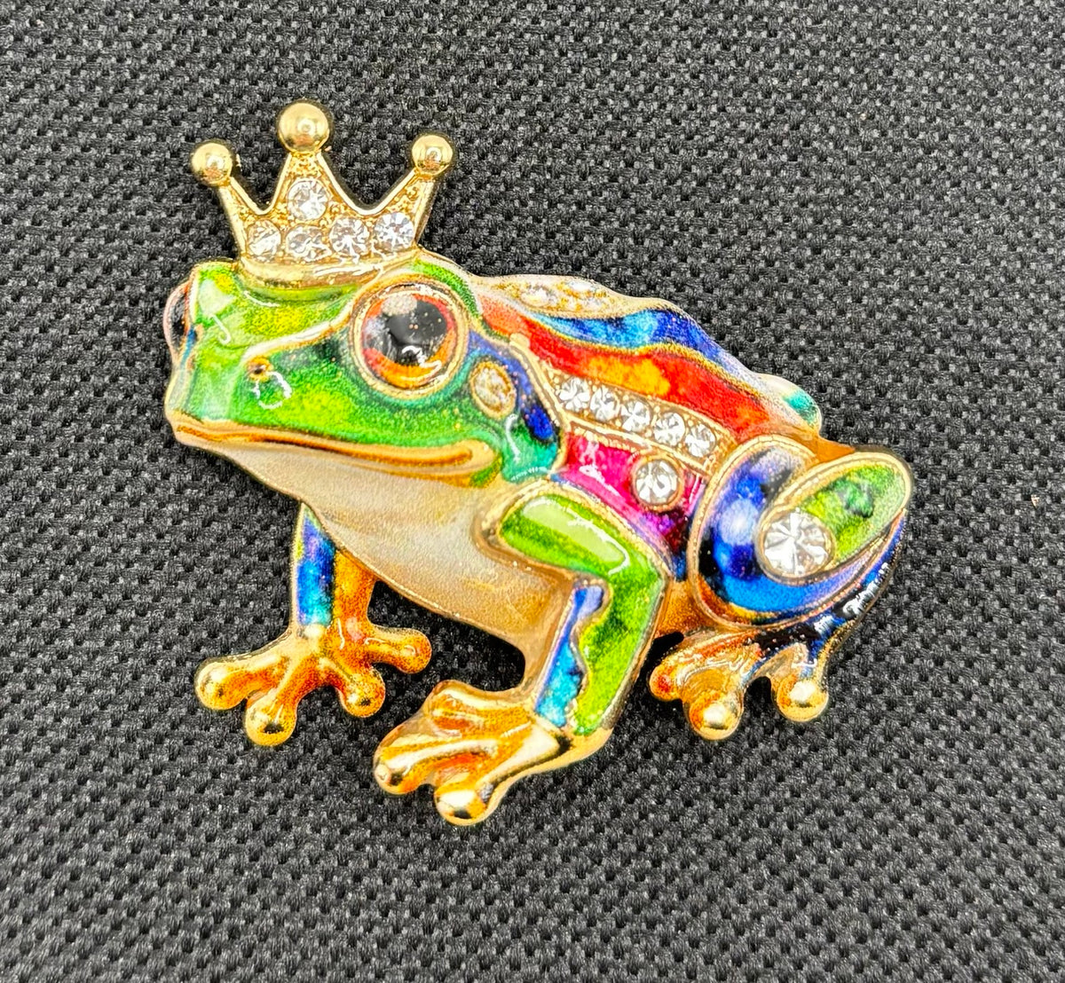 Colorful frog prince needle minder on dark fabric