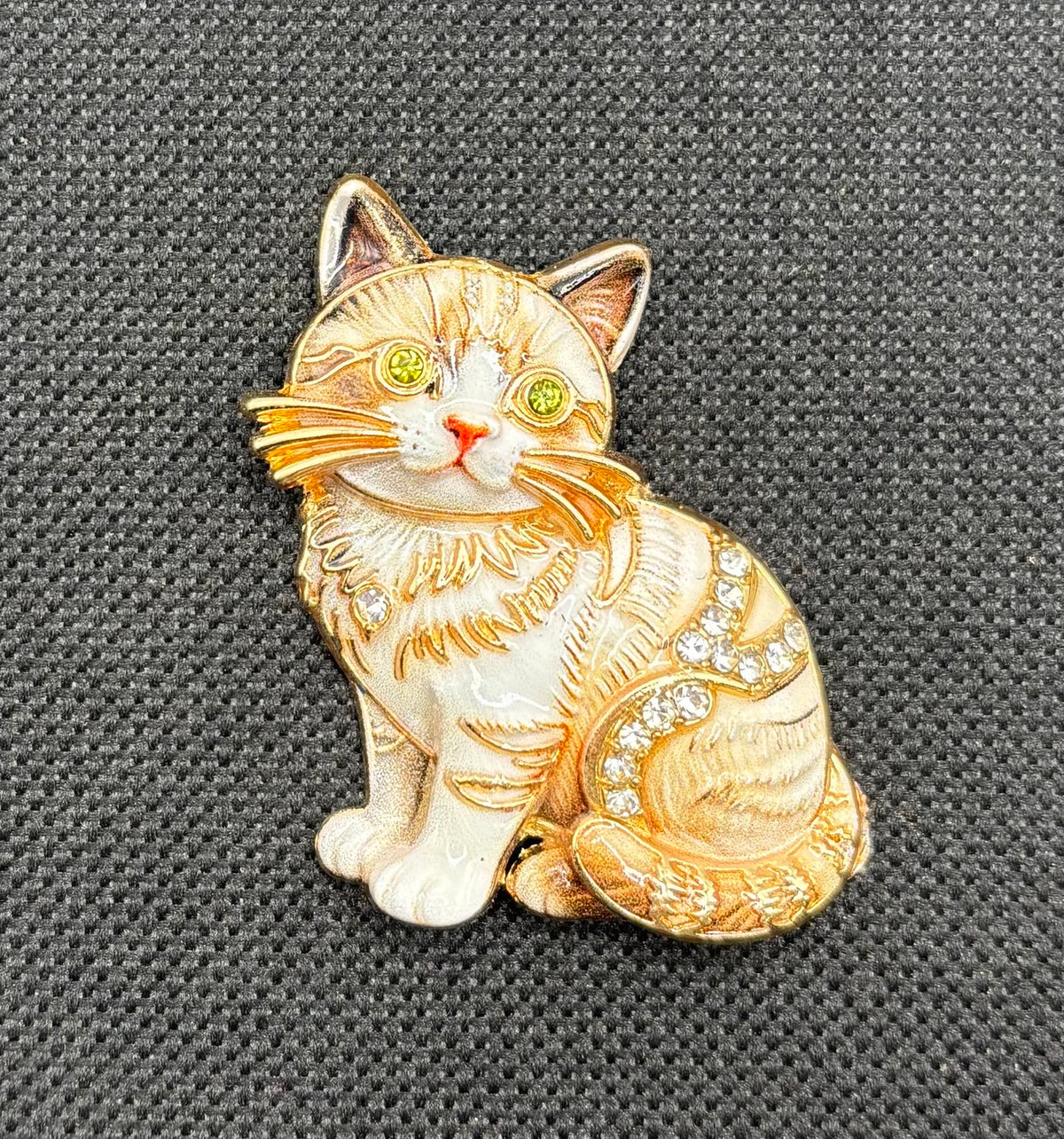 Cream tabby cat kitty needle minder on dark fabric