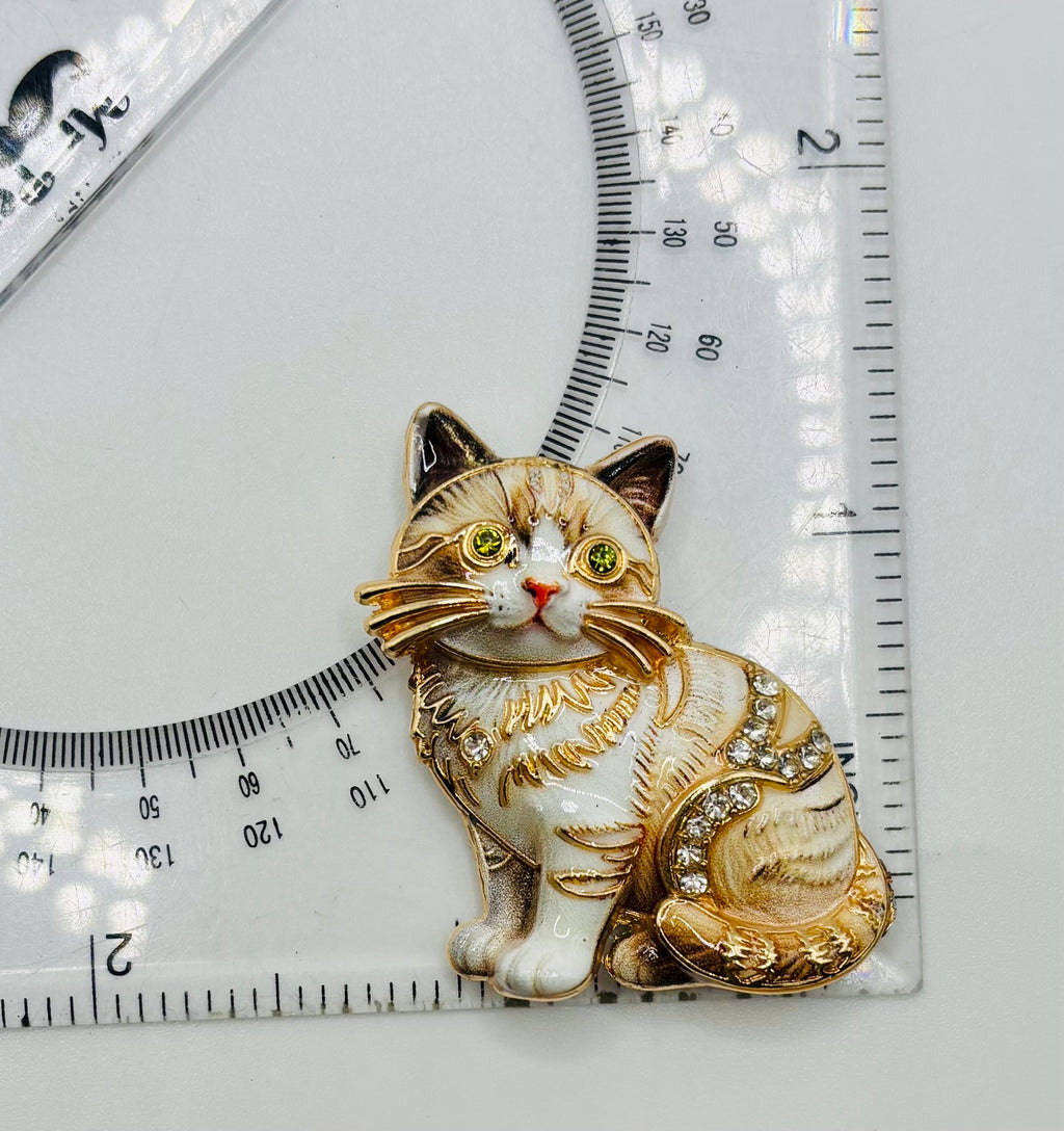 Cream tabby cat kitty needle minder beside a ruler for scale