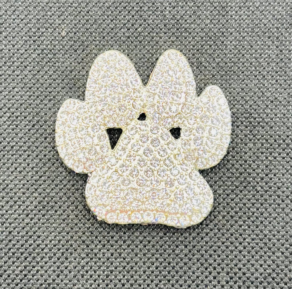 Crystal paw needle minder on dark fabric