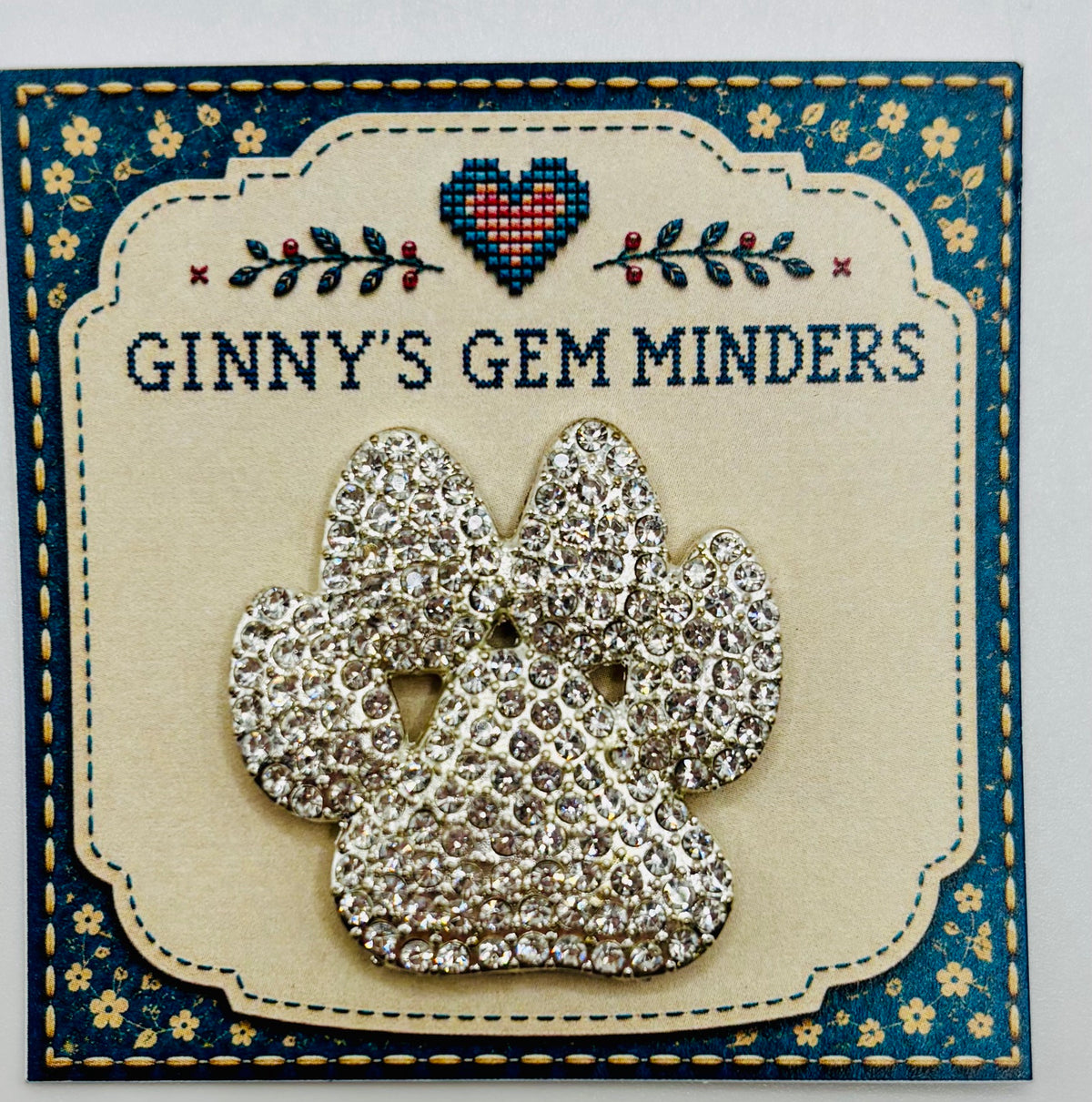 Crystal paw needle minder on display card