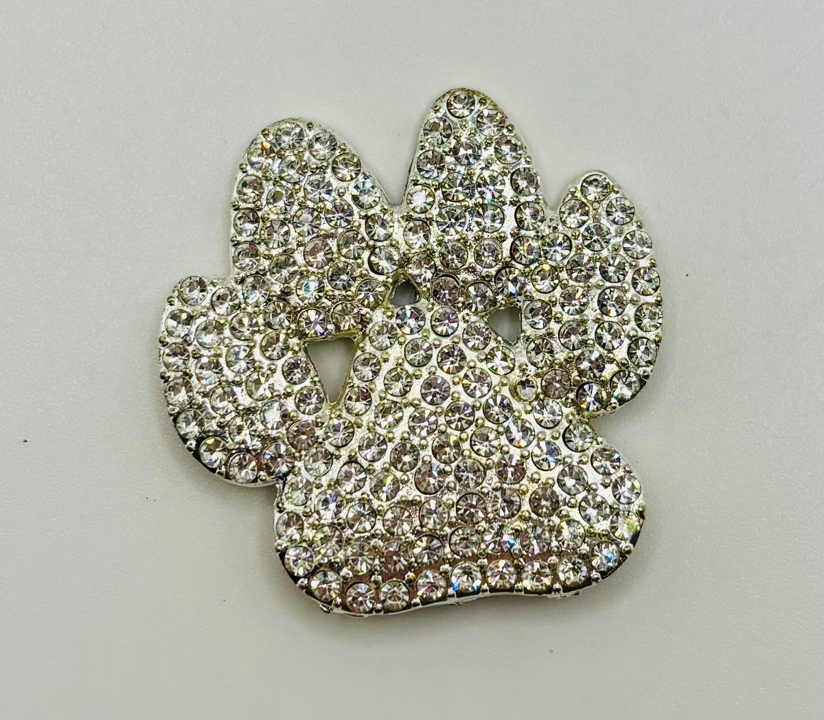 Crystal paw needle minder on white background