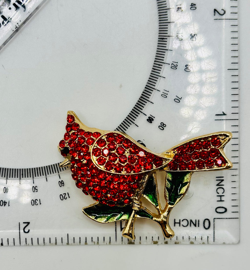 Beautiful Crystal Red Cardinal Needle Minder beside a ruler for scale