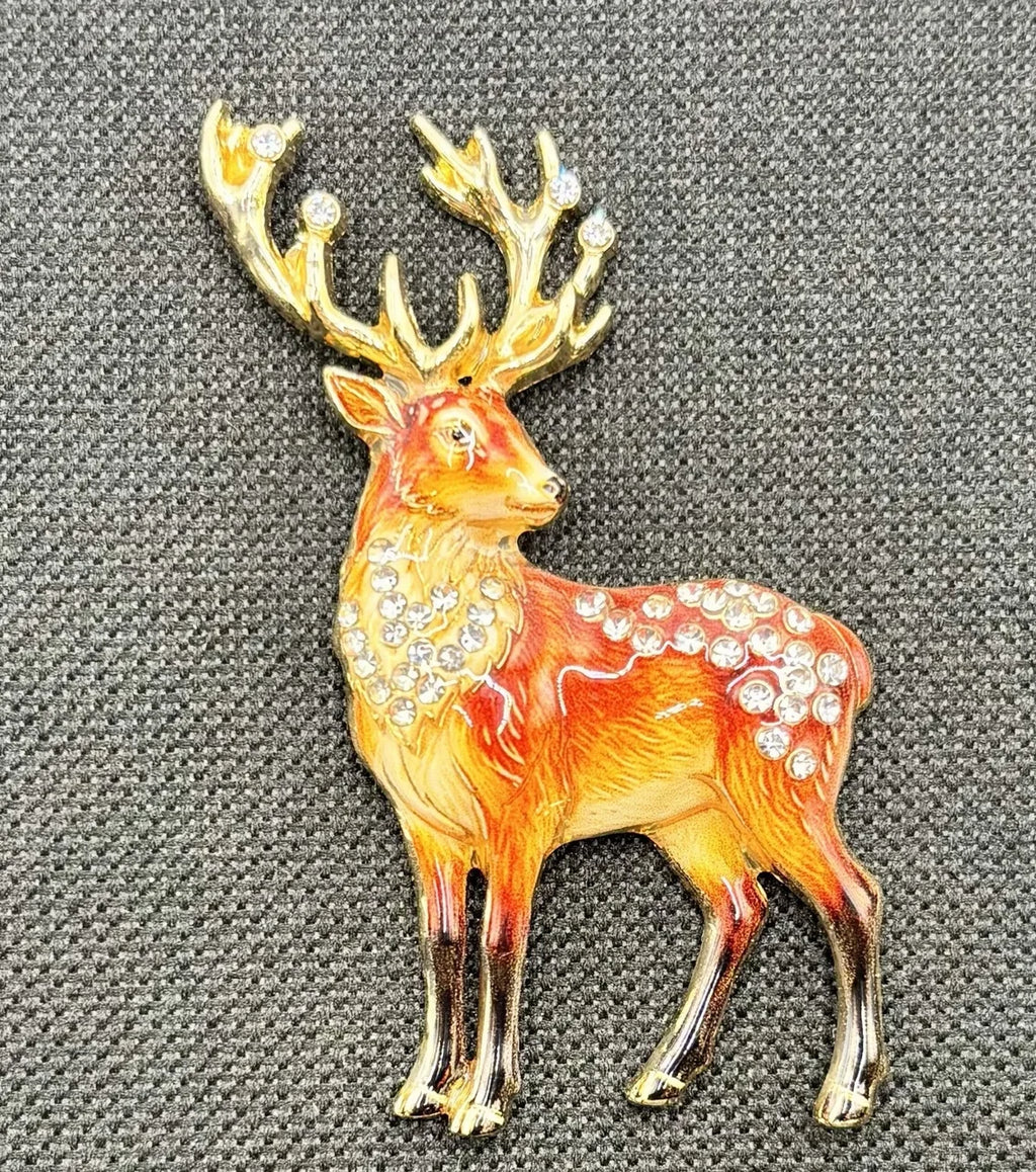 Jeweled deer needle minder on dark fabric