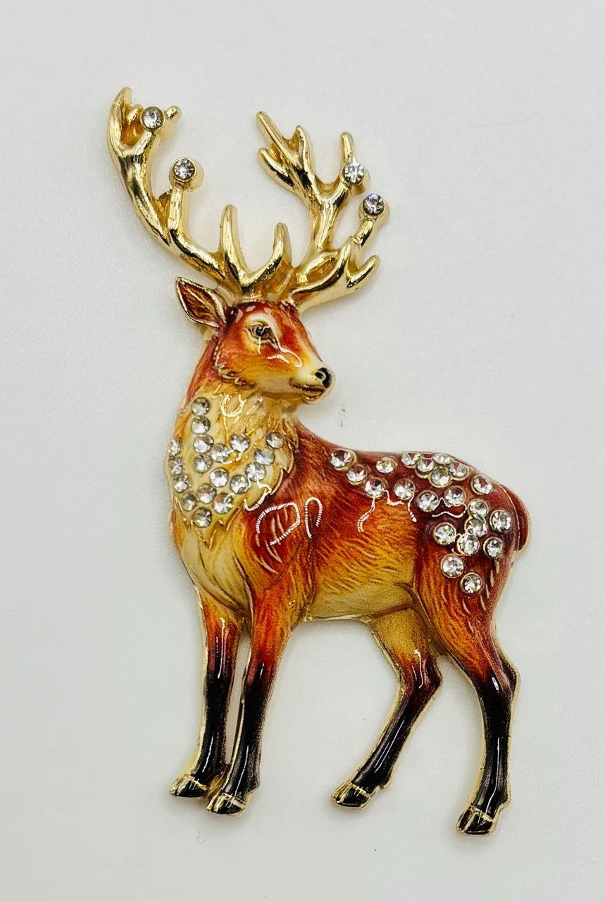 Amber deer needle minder with golden antlers on a white background