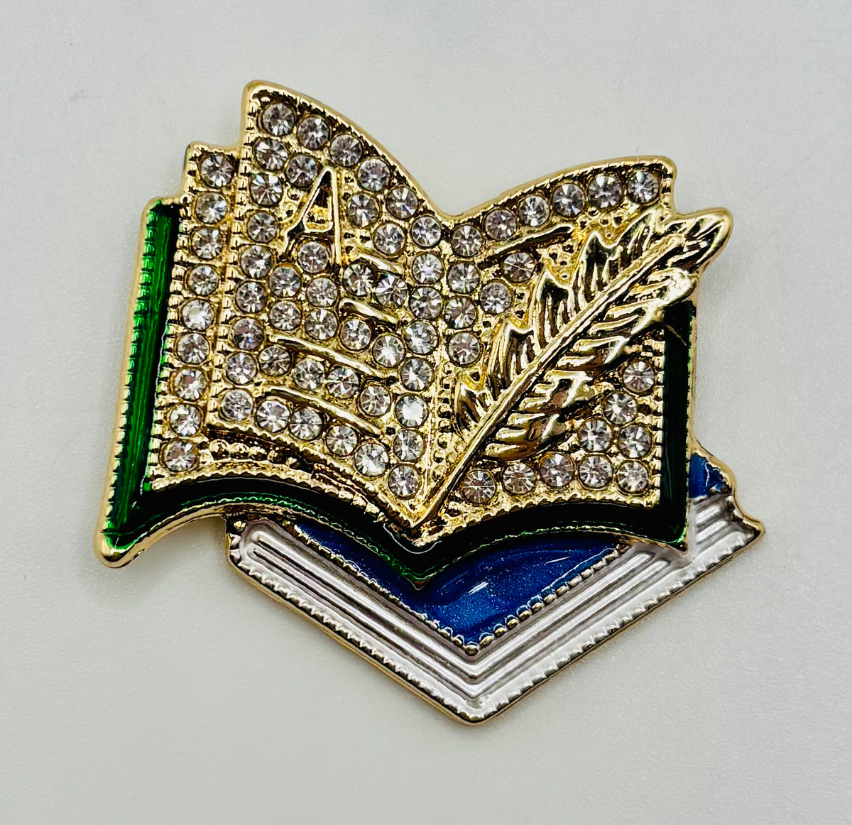 Enamel and Crystal Books Needle Minder — white background