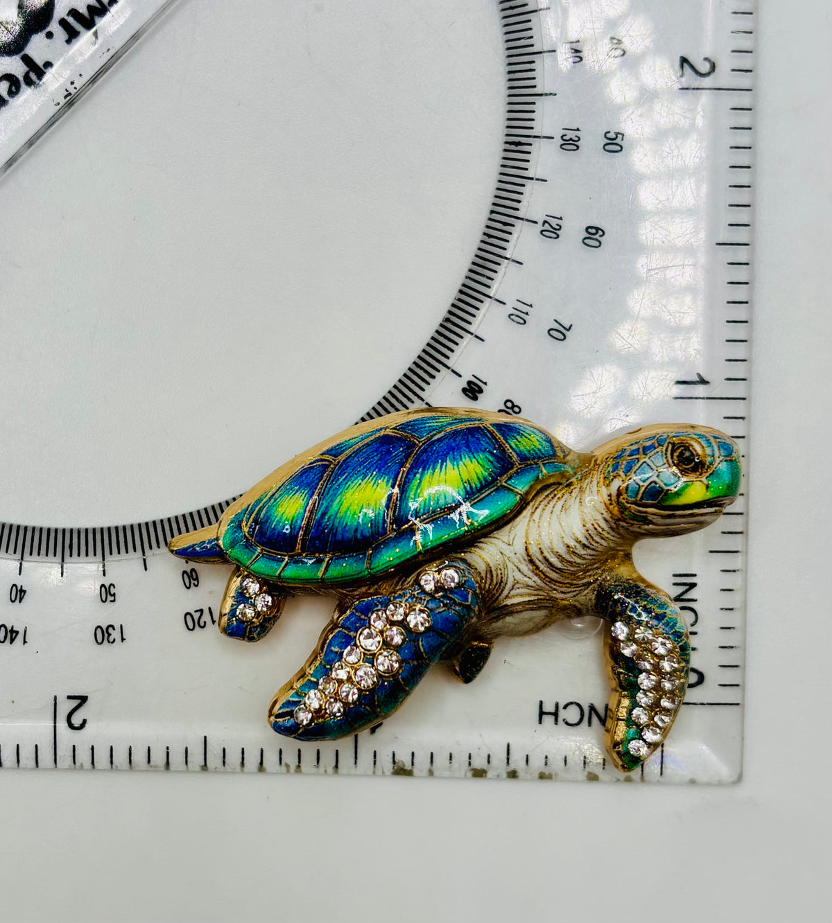 Gorgeous Enamel Crystal Green Sea Turtle Needle Minder beside a ruler for scale