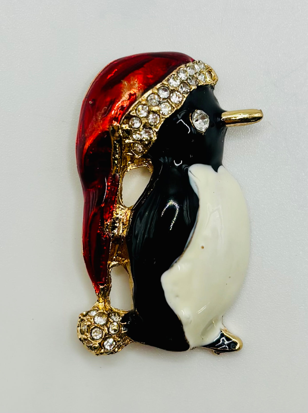 Enamel and crystal penguin needle minder — white background